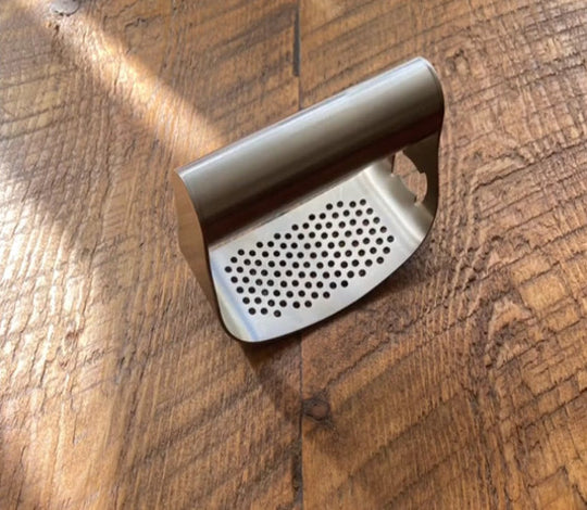 Garlic press rocker that crushes garlic as you rock back and forth